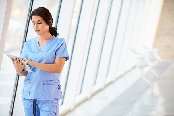 istock Nurse Using Digital Tablet In Corridor Of Modern Hospital 177857701