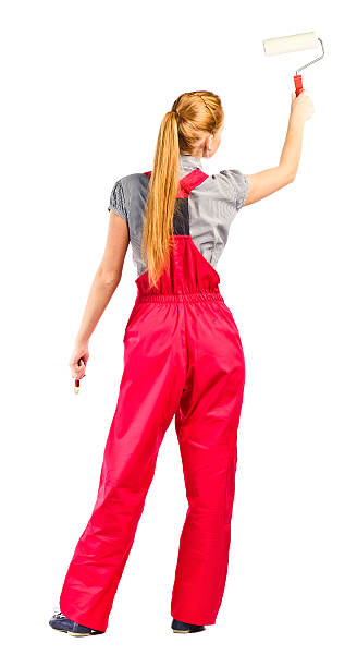 istock Young woman in red overalls with painting tools 177857838