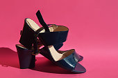 stylish lacquered blue sandals on a pink background. women's summer shoes. an element of the wardrobe.