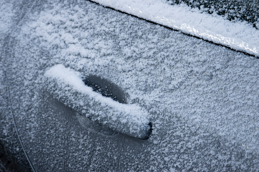 Ice covering car door in a cold winter, Caledonia, Michigan, USA