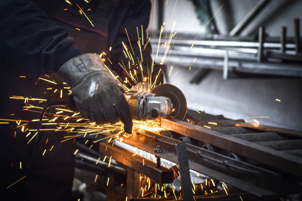 istock Worker cutting metal with grinder. Sparks while grinding iron, in the industrial workshop. 1778589863