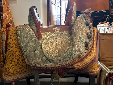 Antique seat for riding a camel, displayed in the medina in Marrakesh