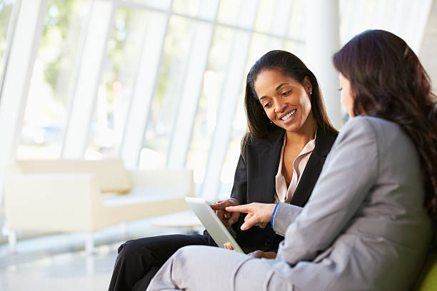 istock Businesswomen With Digital Tablet Sitting In Modern Office 177859481
