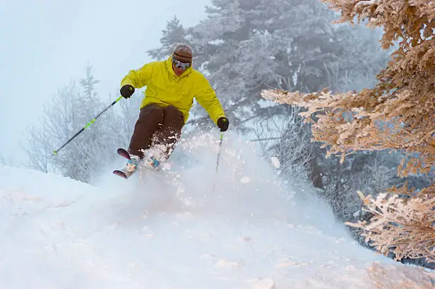 "An expert skier on a powder morning, Stowe, Vermont, USA"