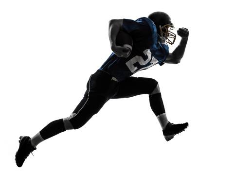 one caucasian american football player man running in silhouette studio on white background