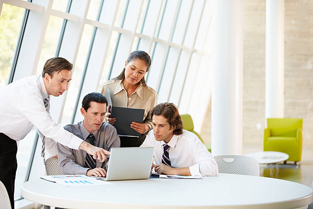 istock Businesspeople Having Meeting Around Table In Modern Office 177859951