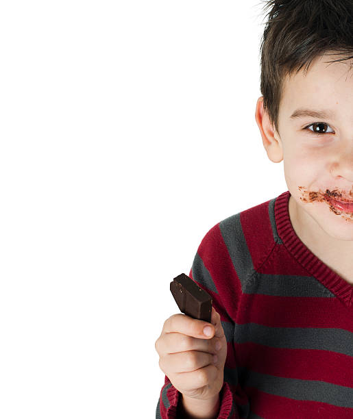 istock Smiling little boy eating chocolate 177860503