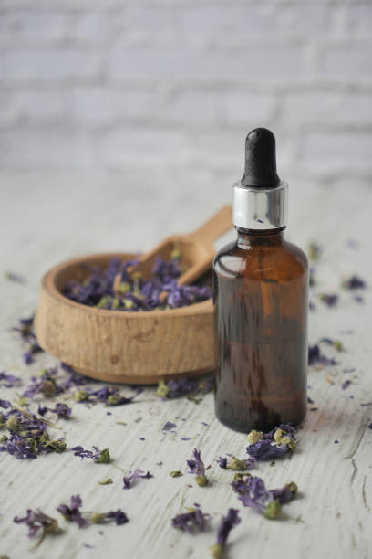 istock Essential lavender oil and flowers on table with copy space 1778614808
