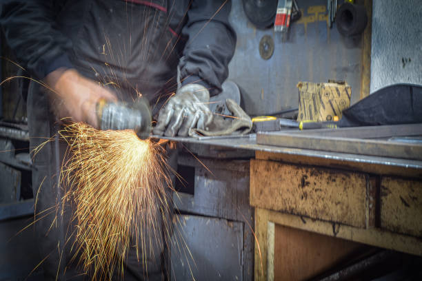 istock Worker cutting metal with grinder. Sparks while grinding iron, in the industrial workshop. 1778620437