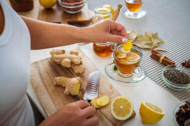 Woman preparing ginger and lemon hot tea