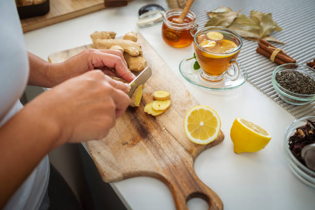 istock Woman slicing ginger and lemon to prepare tea 1778620979
