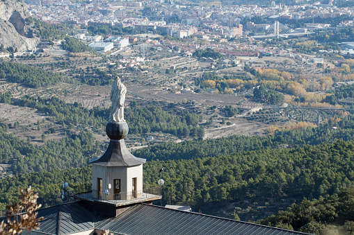 Urban landscape of the city of Alcoi from the Fuente Roja natural park with the Virgin of the Lilies, Spain