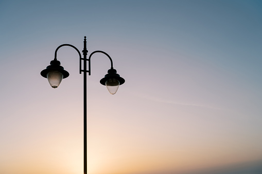 Street double lamp on the background of a colorful sunset. High quality photo