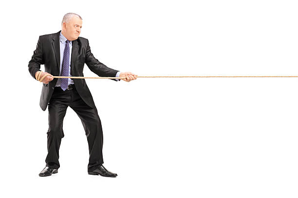 istock Mature businessman in suit pulling a rope 177863785