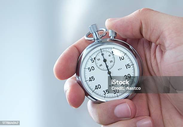 A Man Holding A Stopwatch On His Hand Stock Photo - Download Image Now - Stopwatch, Men, People
