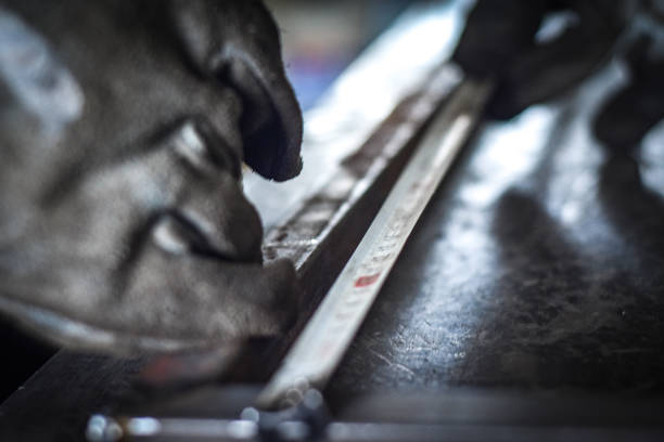 istock Worker measuring off metal bar in industrial workshop. 1778641956