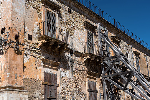 03/25/2023 Ispica, Sicily,Italy: old abandoned and decaying house supported by a large scaffolding, in a small Sicilian village
