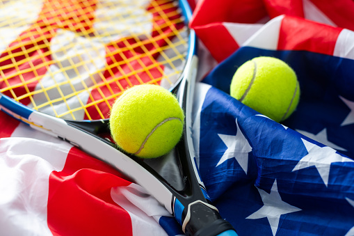 Tennis tournament: racket, balls and American flag, sports and competition concept. High quality photo