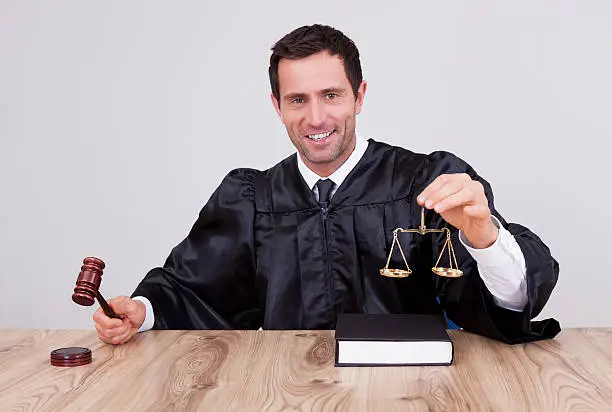 Photo of Male Judge Holding Scale