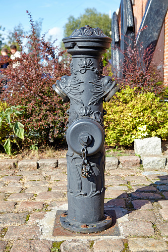 Old cast iron fire hydrant with beautiful patterns.