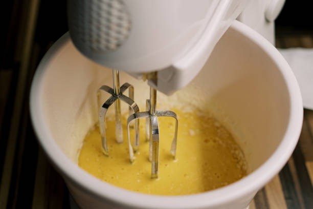 istock Mixer beats the eggs in a bowl on the table. Top view 1778680495