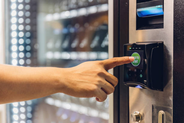 istock Hand man use of soft drink vending system. Man use drink coin machine at smart office or Public park. People use  Vending Machine, is robotic for the high-quality drink 1778685418