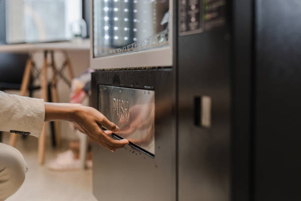 istock hand pushing button on vending machine operation panel. Hand man use of soft drink vending system. Technology and consumption concept. People choosing a snack or drink at vending machine 1778685817
