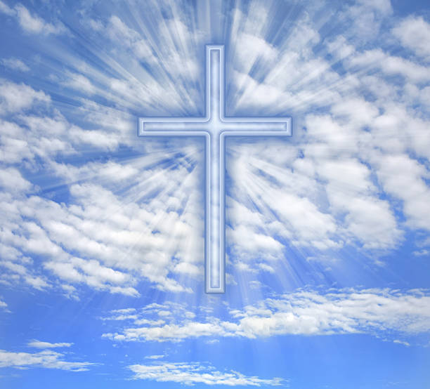 istock Christian cross with light beams over sky 177868905