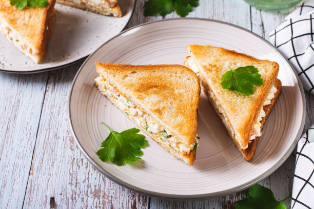 istock Bacon, egg and herb salad in a trendy chopped grilled sandwich on a plate 1778694908