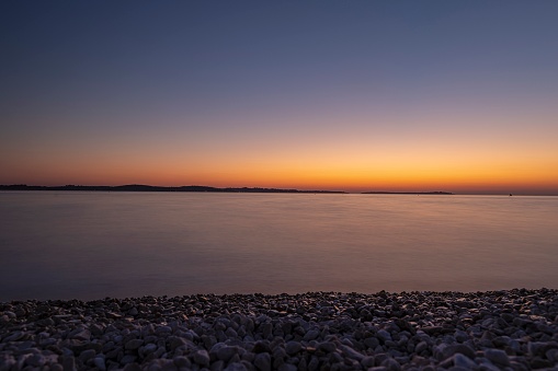 Sunset on the beach in the Croatian coastal town of Fazana in summer