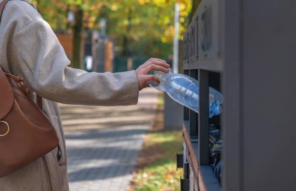 istock the girl throws the empty bottle into the trash 1778702698
