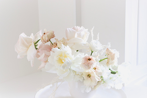 Luxury Fresh flower arrangement on white table in elegant setting with white background