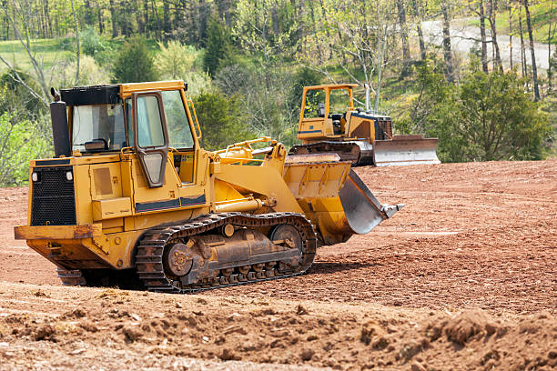 amplio cavadora mecánica digger compensación tierra - bulldozer fotografías e imágenes de stock