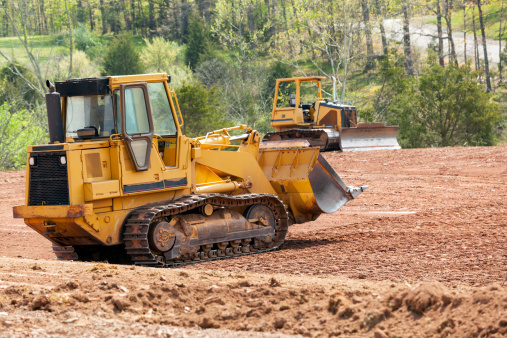 Large earth mover digger clearing land