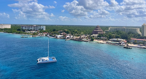 Catamaran, turquoise water and the shoreline of Cozumel, Mexico