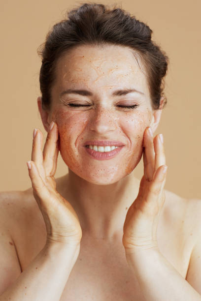 istock smiling young woman with face scrub isolated on beige 1778720459