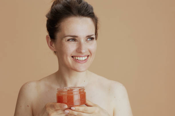 istock smiling modern woman with face scrub 1778720460