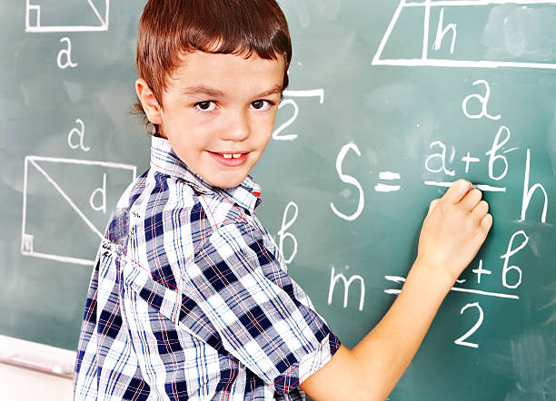 istock School child writting on blackboard. 177873979