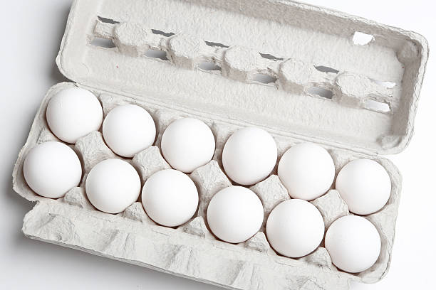 White eggs in carton. Nutritious eating. stock photo
