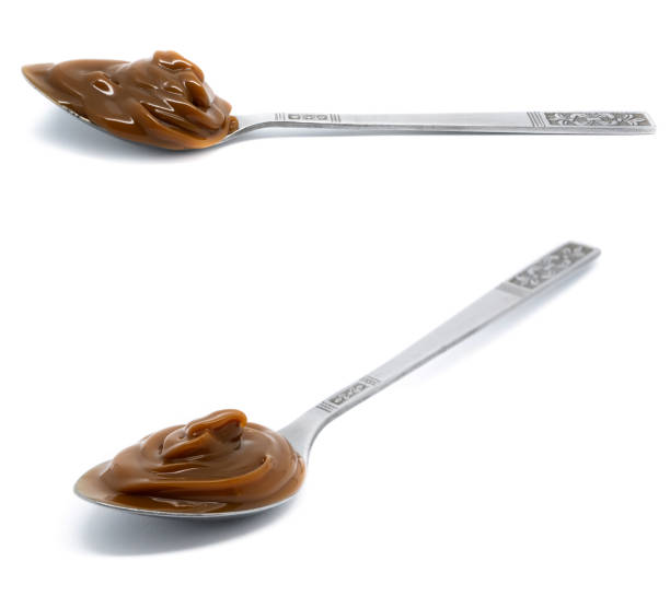 istock Dulce de leche in a metal spoon on isolated background. 1778742539