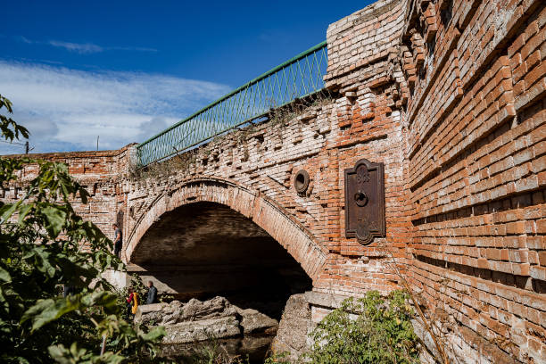 istock Ancient stone bridge over the river. Brick construction of the bridge. Arch construction for crossing the water. 1778748619