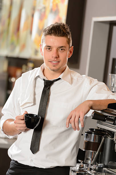 istock Attractive waiter leaning on espresso machine 177875299