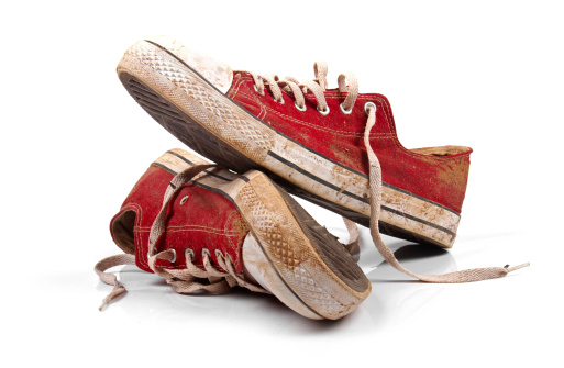 pair of dirty sneakers isolated on white background