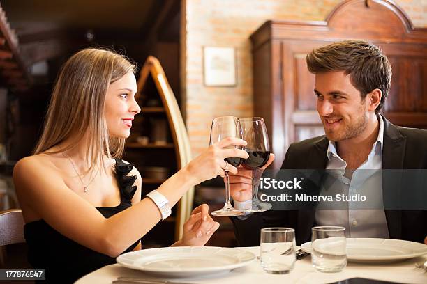 Elegant Couple Clinking Wine Glasses At A Nice Restaurant Stock Photo - Download Image Now