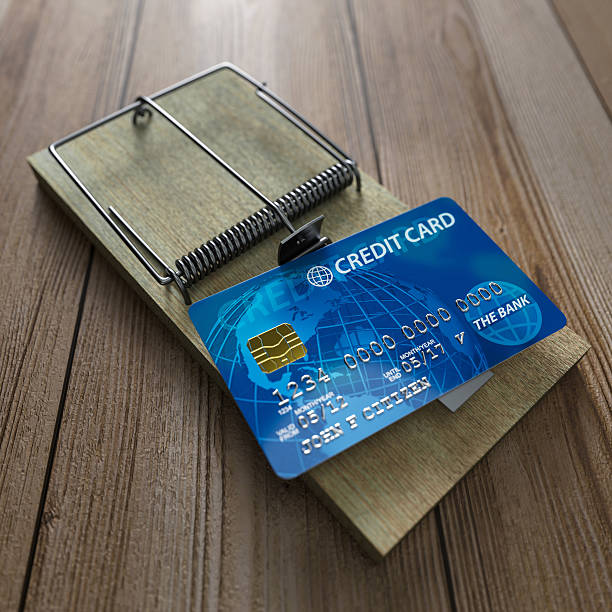 istock A mouse trap with a credit card on a wooden floor 177877262