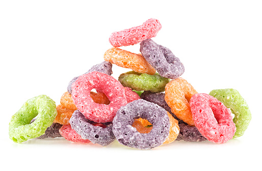 Pile of sweet crispy corn rings isolated on a white background. Cereal breakfast. Fruit loops. Colorful corn cereals.