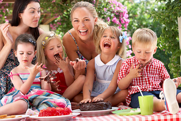 kinder und mütter essen kuchen im freien tea-party - party tea party tea child stock-fotos und bilder