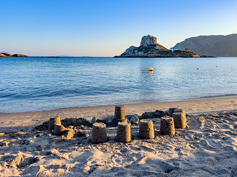 View of the small island of Kastri near Kos in the Bay of Kamari, Greece. A natural view of Kefalos beach on a hot summer evening. Destination background with copy space.