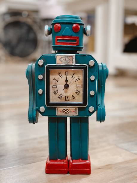 istock an old blue robot is standing on the floor and holding a clock 1778839651