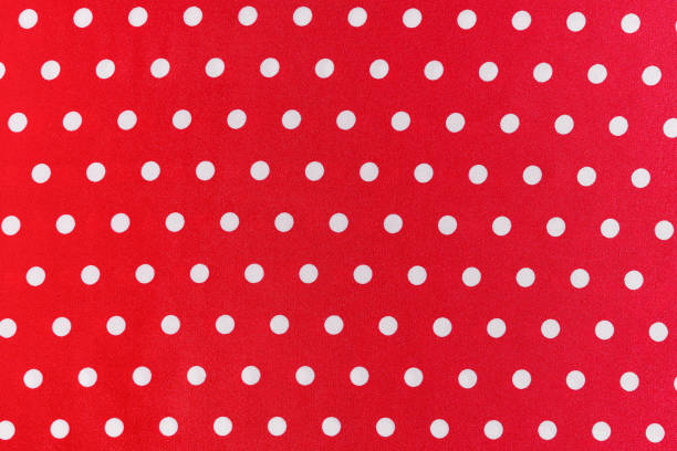 istock texture of red silk or polyester fabric with white polka dots close-up. background for your design. material for sewing dresses, skirts or shirts 1778853266